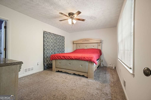 408 Walnut Dr, Woodstock, GA 30189 - carpeted bedroom featuring a textured ceiling, a ceiling fan, and baseboards