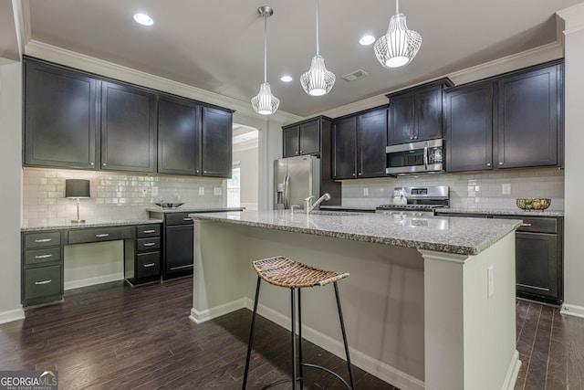 207 Cherokee Reserve Cir, Canton, GA 30115 - kitchen with appliances with stainless steel finishes, visible vents, ornamental molding, dark wood finished floors, and backsplash