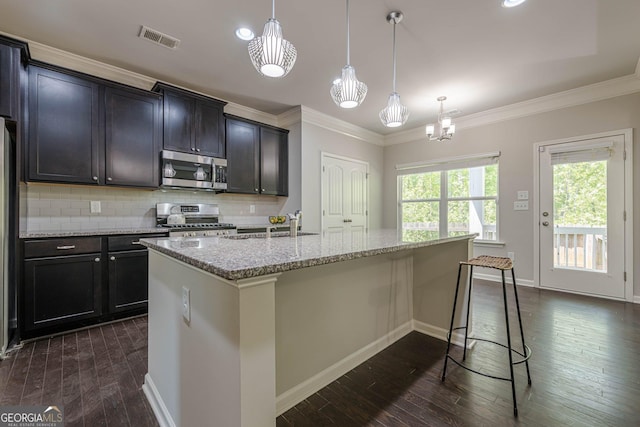 207 Cherokee Reserve Cir, Canton, GA 30115 - kitchen featuring tasteful backsplash, appliances with stainless steel finishes, ornamental molding, dark wood-style floors, and visible vents