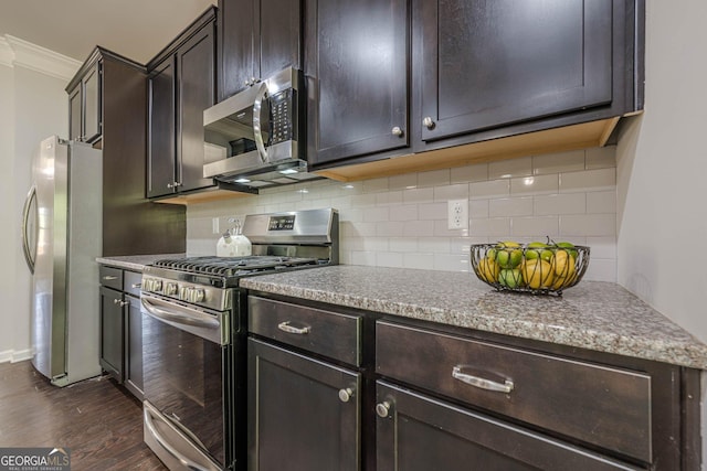 207 Cherokee Reserve Cir, Canton, GA 30115 - kitchen featuring decorative backsplash, stainless steel appliances, dark brown cabinetry, ornamental molding, and dark wood finished floors