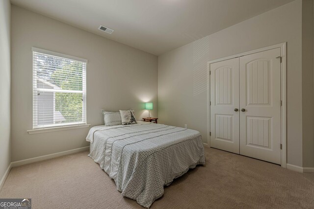 207 Cherokee Reserve Cir, Canton, GA 30115 - carpeted bedroom with visible vents, a closet, and baseboards
