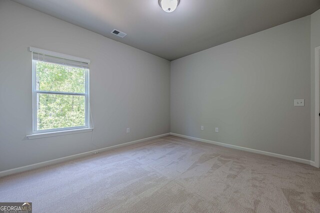 207 Cherokee Reserve Cir, Canton, GA 30115 - spare room featuring baseboards, visible vents, a healthy amount of sunlight, and light colored carpet