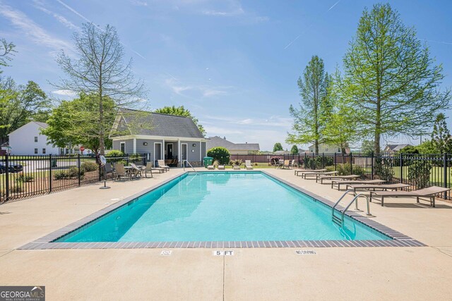 207 Cherokee Reserve Cir, Canton, GA 30115 - community pool with fence and a patio area