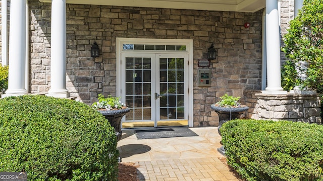 doorway to property featuring french doors and stone siding
