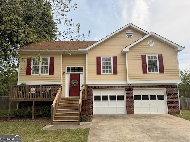 700 Muirfield Dr, Winder, GA 30680 - raised ranch featuring driveway, a deck, fence, brick siding, and a garage