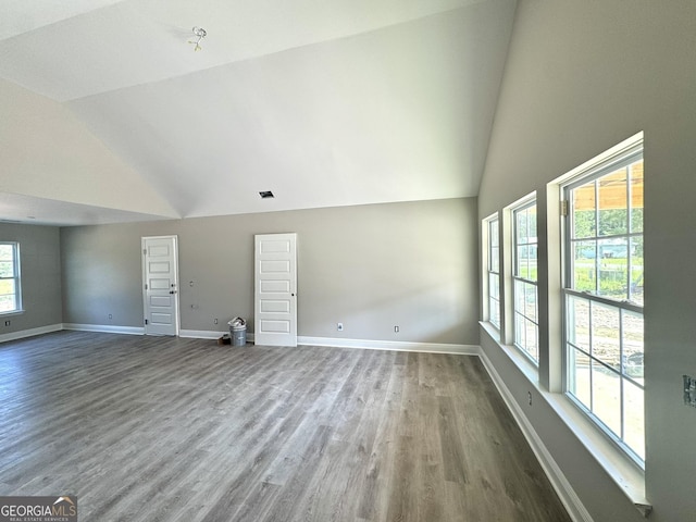 270 Abigail Cir, Ellabell, GA 31308 - unfurnished living room featuring wood finished floors, baseboards, and high vaulted ceiling