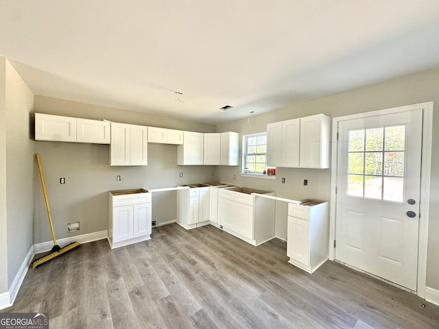 270 Abigail Cir, Ellabell, GA 31308 - kitchen with wood finished floors, white cabinetry, and baseboards