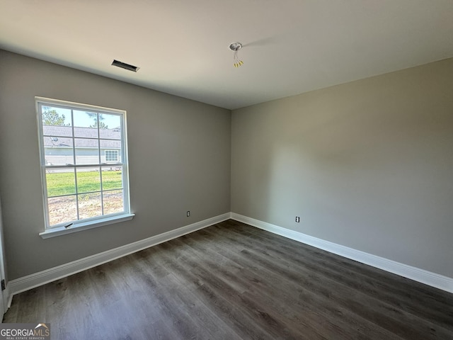 270 Abigail Cir, Ellabell, GA 31308 - empty room with dark wood-style flooring, baseboards, and plenty of natural light