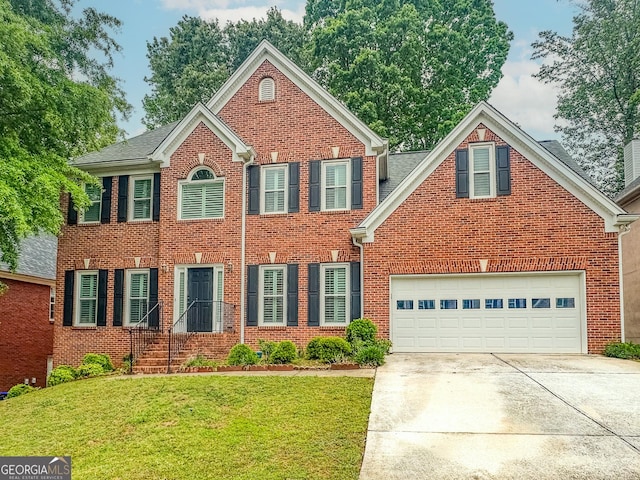 1485 Oglethorpe Run Ln, Suwanee, GA 30024 - colonial inspired home with a front yard, an attached garage, concrete driveway, and brick siding