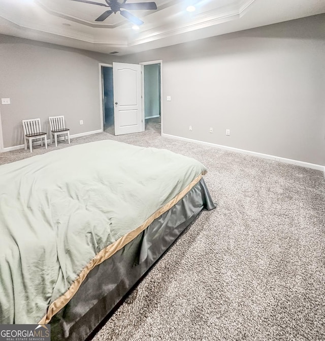 1485 Oglethorpe Run Ln, Suwanee, GA 30024 - carpeted bedroom with ornamental molding, a ceiling fan, baseboards, and a tray ceiling