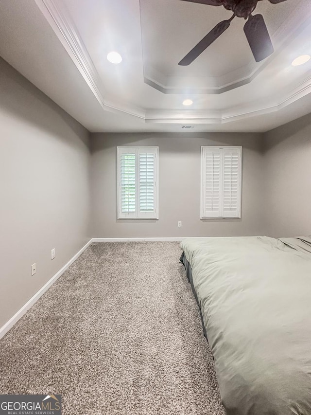 1485 Oglethorpe Run Ln, Suwanee, GA 30024 - unfurnished bedroom with carpet floors, a ceiling fan, a tray ceiling, and baseboards