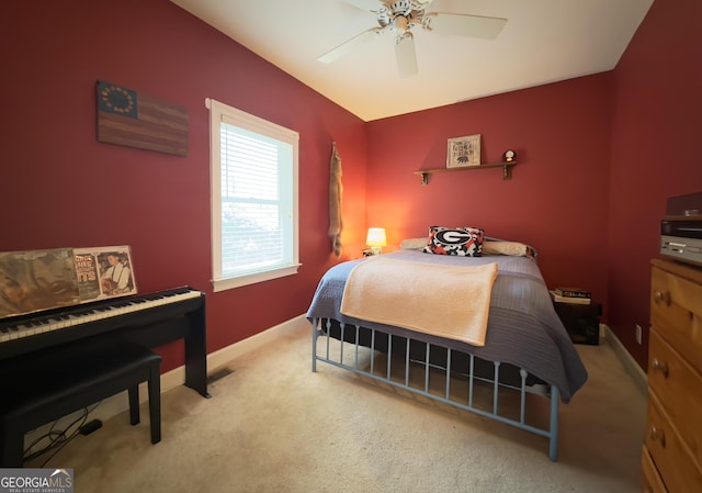 bedroom featuring baseboards, a ceiling fan, and light carpet