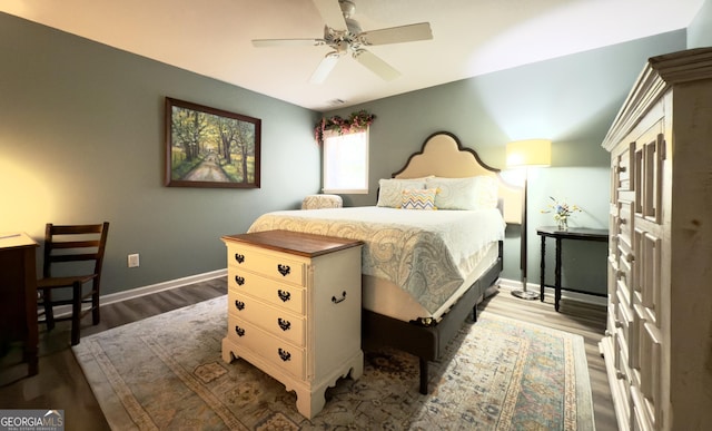 bedroom featuring wood finished floors, a ceiling fan, and baseboards