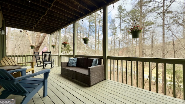 wooden terrace featuring outdoor lounge area