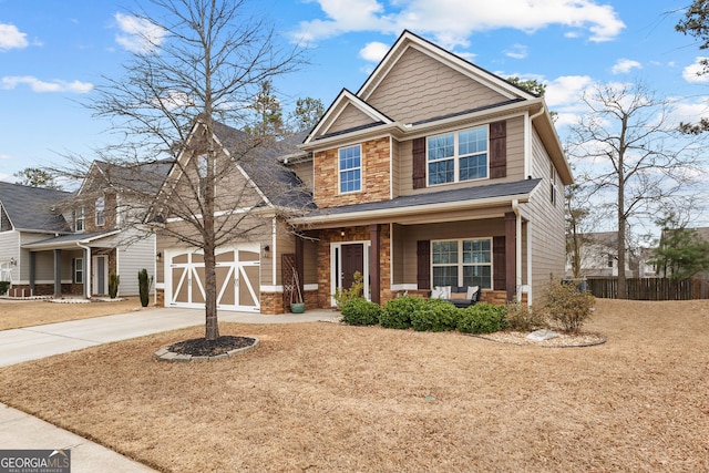 171 Cliffhaven Cir, Newnan, GA 30263 - craftsman-style home with covered porch, fence, concrete driveway, and stone siding