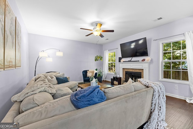 171 Cliffhaven Cir, Newnan, GA 30263 - living area featuring ceiling fan, a tiled fireplace, baseboards, wood finished floors, and visible vents