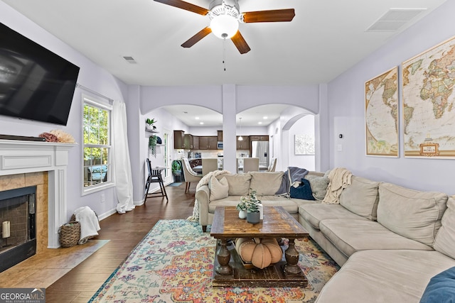 171 Cliffhaven Cir, Newnan, GA 30263 - living room featuring visible vents, arched walkways, ceiling fan, and a fireplace
