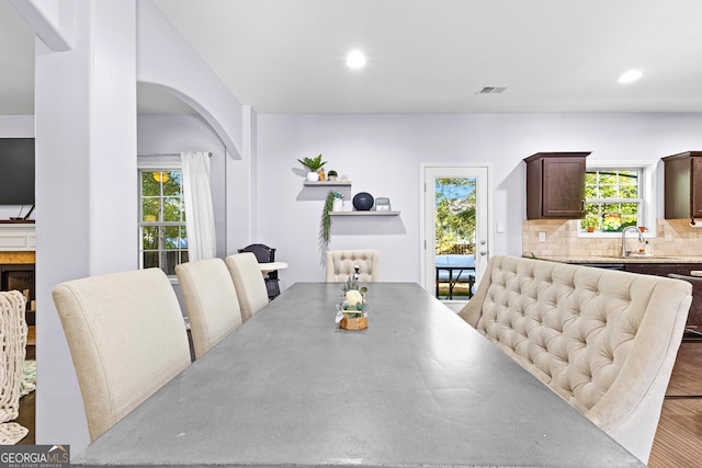 171 Cliffhaven Cir, Newnan, GA 30263 - dining area featuring a healthy amount of sunlight, visible vents, arched walkways, wood finished floors, and recessed lighting