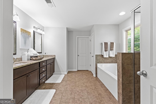171 Cliffhaven Cir, Newnan, GA 30263 - bathroom with a sink, double vanity, baseboards, visible vents, and a garden tub