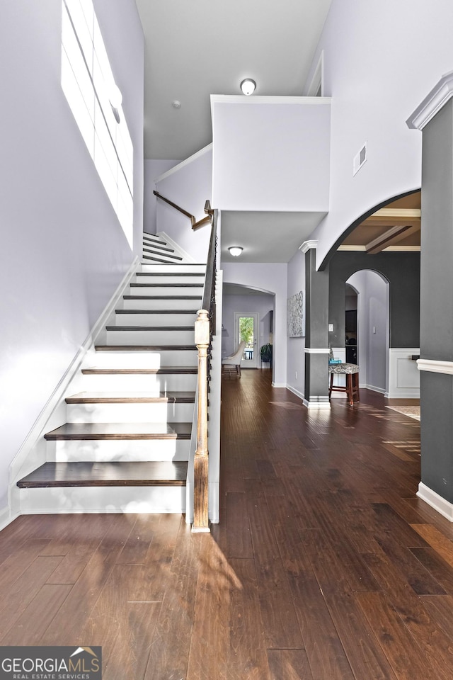 171 Cliffhaven Cir, Newnan, GA 30263 - stairs featuring a high ceiling, wood-type flooring, arched walkways, baseboards, and visible vents