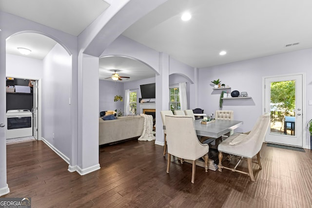 171 Cliffhaven Cir, Newnan, GA 30263 - dining space with ceiling fan, visible vents, arched walkways, a fireplace, and wood finished floors