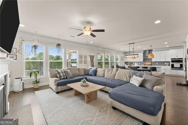 837 Porches Way, Dacula, GA 30019 - living area with recessed lighting, a ceiling fan, a fireplace, wood finished floors, and ornamental molding