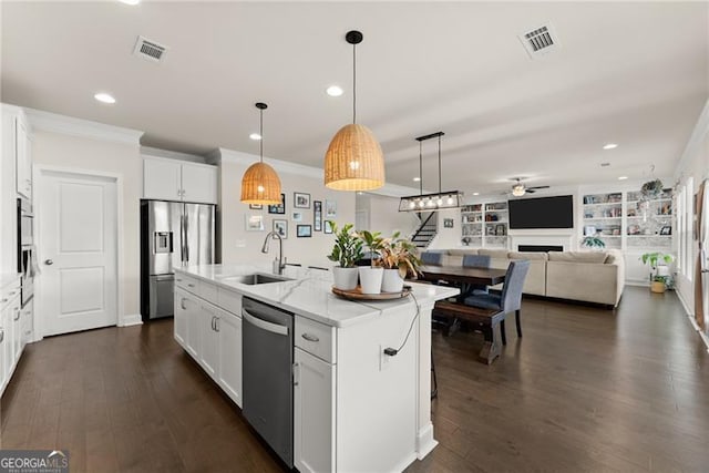 837 Porches Way, Dacula, GA 30019 - kitchen with stainless steel appliances, ceiling fan, a fireplace, crown molding, and an island with sink