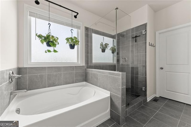 837 Porches Way, Dacula, GA 30019 - bathroom featuring plenty of natural light, a garden tub, and a stall shower