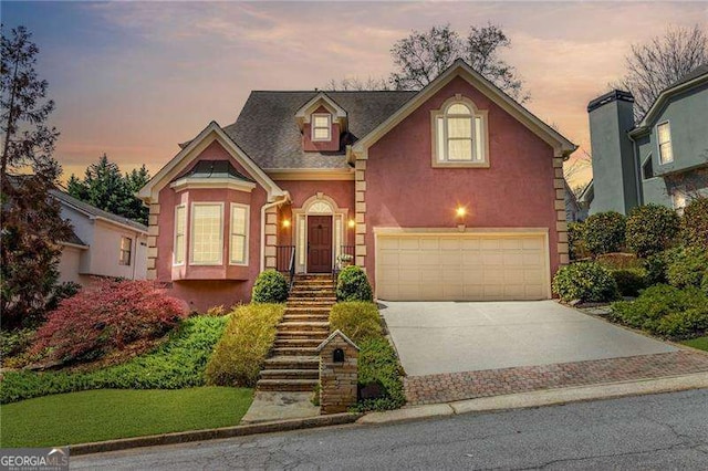 3720 Harts Pl, Atlanta, GA 30341 - traditional home featuring an attached garage, driveway, stairway, and stucco siding