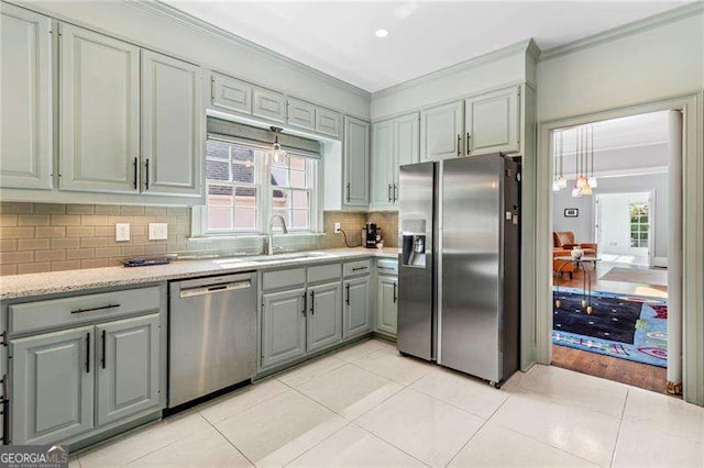 3720 Harts Pl, Atlanta, GA 30341 - kitchen featuring a sink, tasteful backsplash, ornamental molding, gray cabinetry, and appliances with stainless steel finishes