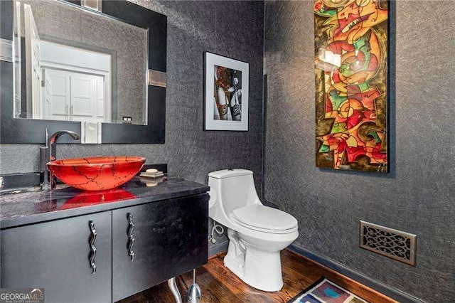 3720 Harts Pl, Atlanta, GA 30341 - bathroom featuring visible vents, wallpapered walls, toilet, wood finished floors, and vanity