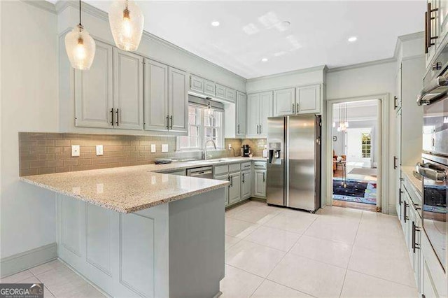 3720 Harts Pl, Atlanta, GA 30341 - kitchen featuring crown molding, stainless steel appliances, gray cabinets, a peninsula, and backsplash