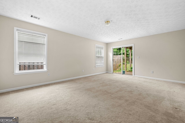 1452 Evanston Ln, Marietta, GA 30062 - spare room with a textured ceiling, visible vents, light colored carpet, and baseboards