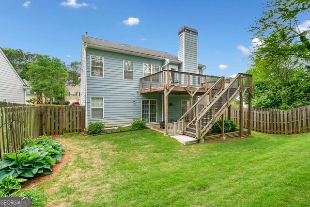1452 Evanston Ln, Marietta, GA 30062 - back of property with a chimney, a fenced backyard, stairs, a wooden deck, and a lawn