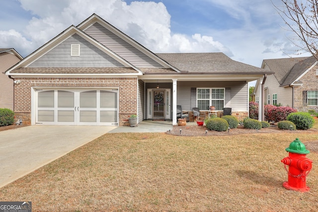 view of front facade featuring covered porch, a shingled roof, driveway, a front lawn, and an attached garage