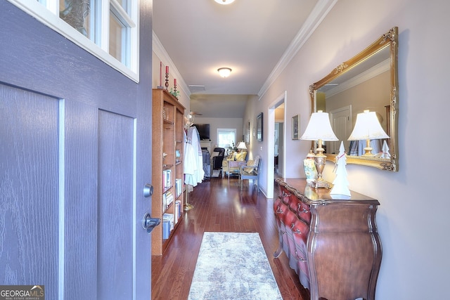 foyer entrance featuring visible vents, ornamental molding, and dark wood-type flooring