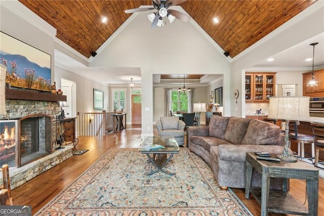 living room featuring a ceiling fan, ornamental molding, wood finished floors, high vaulted ceiling, and recessed lighting