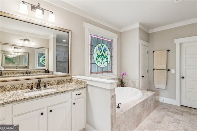 bathroom featuring a garden tub, crown molding, vanity, and baseboards