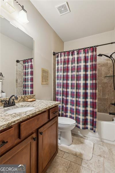 bathroom with toilet, vanity, and shower / bath combo