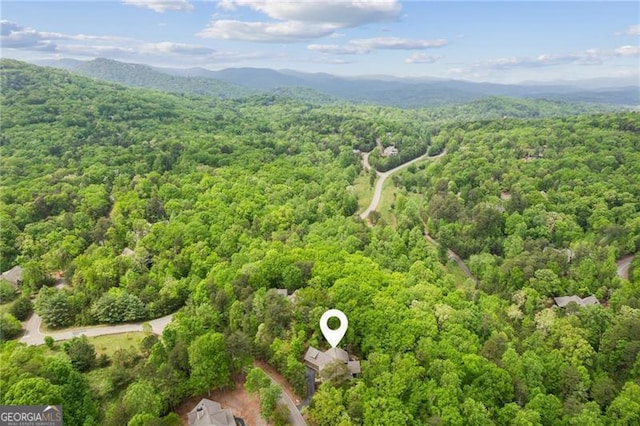 bird's eye view of a heavily wooded area and mountains