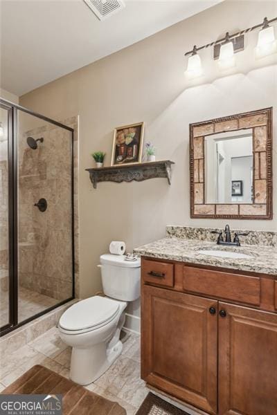 full bath featuring a shower stall, toilet, and vanity
