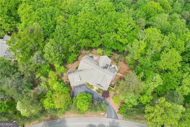 view of subject property featuring a heavily wooded area