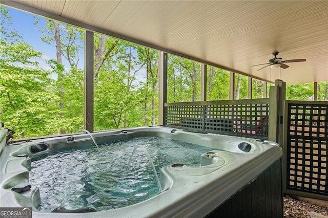 sunroom / solarium with a hot tub and ceiling fan