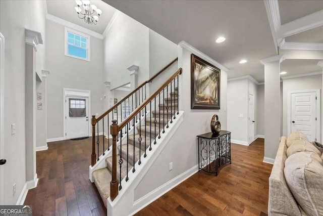 stairs with baseboards, ornamental molding, a healthy amount of sunlight, and hardwood / wood-style floors