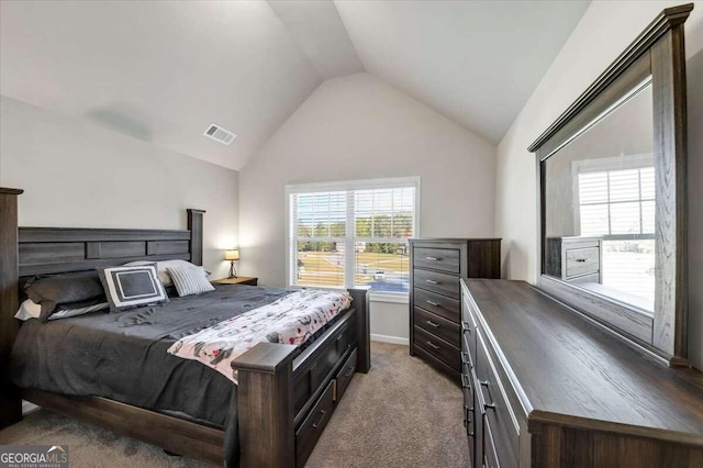carpeted bedroom featuring lofted ceiling and visible vents