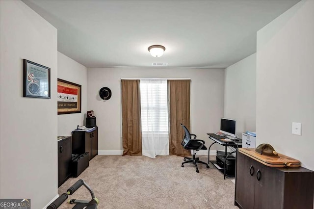 office space with baseboards, visible vents, and light colored carpet
