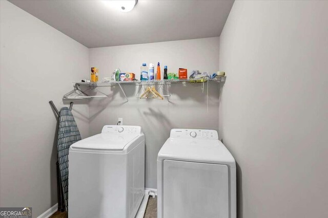 laundry room featuring separate washer and dryer, laundry area, and baseboards