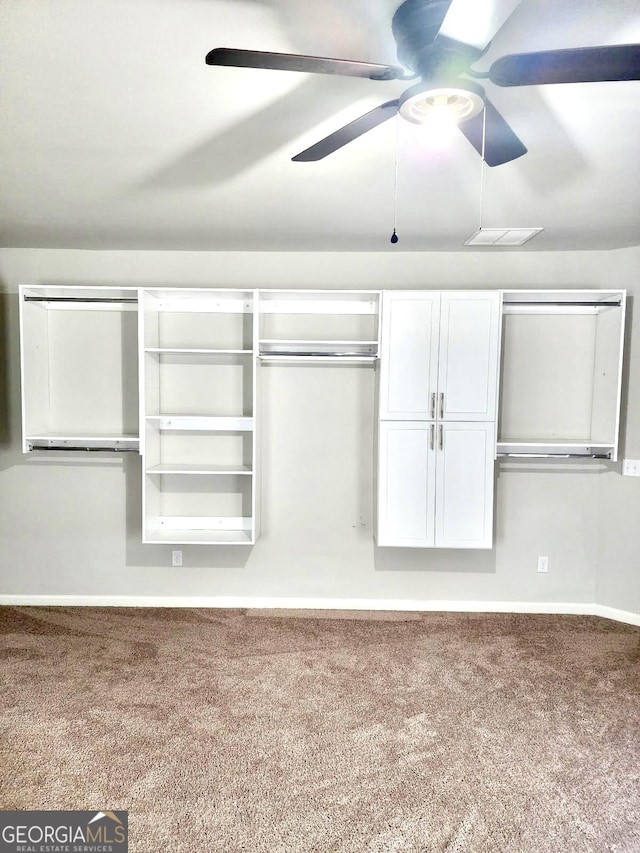 interior space featuring ceiling fan, multiple closets, carpet, and baseboards