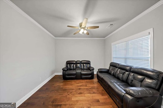 living room with wood finished floors, baseboards, visible vents, a ceiling fan, and crown molding