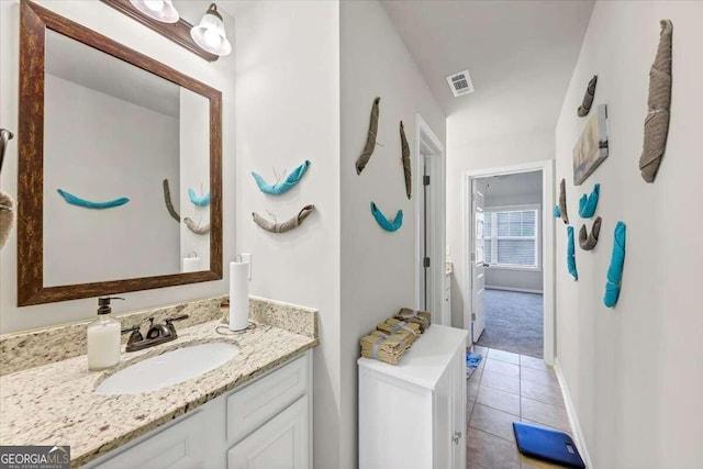 bathroom featuring visible vents, vanity, tile patterned flooring, and baseboards